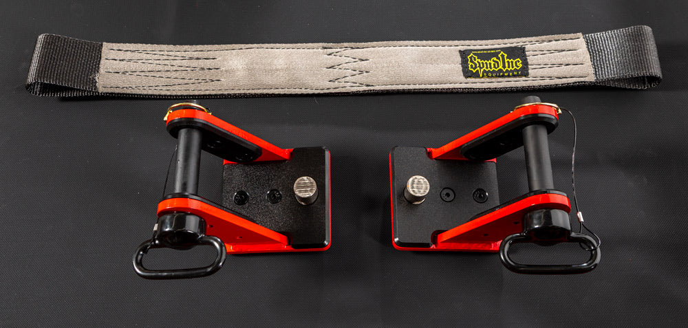 Two red and black straps with a gray strap on a dark background